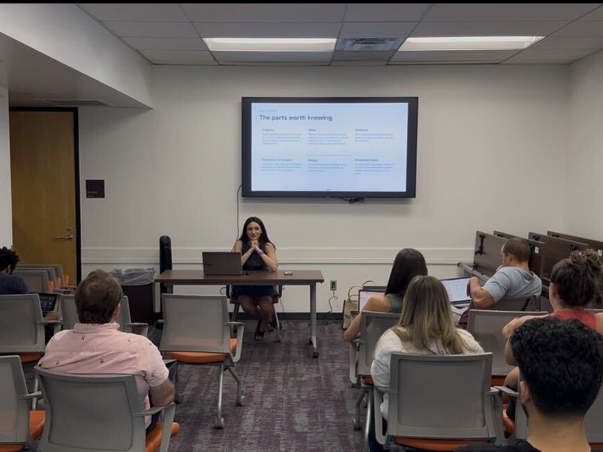 The full room at the first meetup, with the presenter at the front table and the audience seated